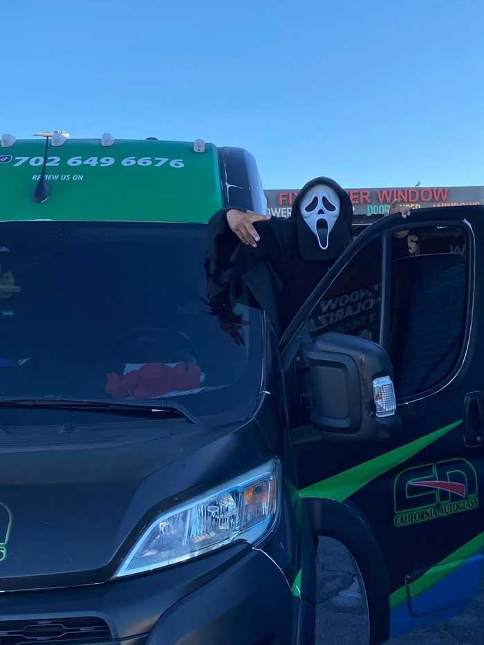 Halloween-costumed Las Vegas team member beside a branded mobile service van
