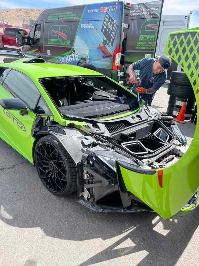Technician preparing the windshield opening of a green Lamborghini Huracán STO