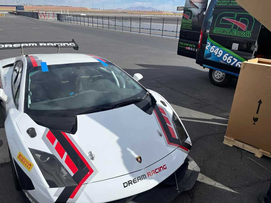 White Dream Racing Lamborghini with a newly fitted windshield and blue retention tape