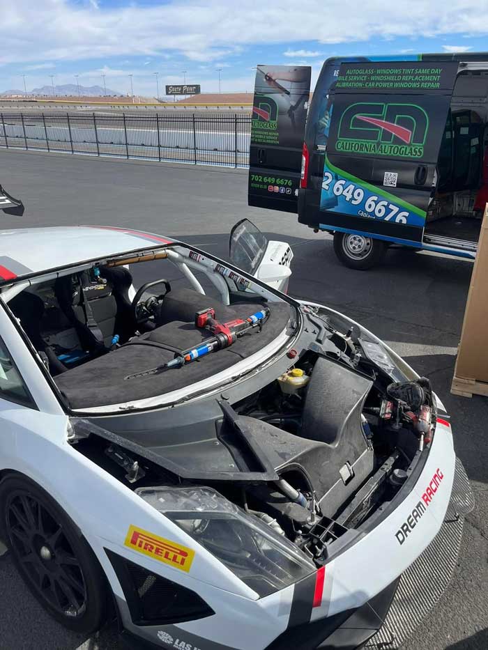 Lamborghini with its windshield removed and replacement tools beside the opening